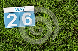 May 26th. Day 26 of month, calendar on football green grass background. Spring time, empty space for text photo