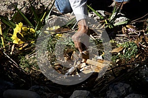 Mayan priest preparing ritual fire with wood and candles