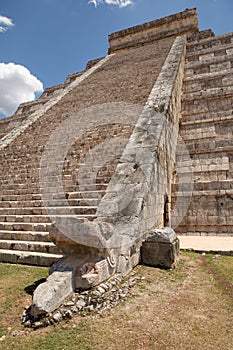 Mayan temple stairs with carved snake head at the base