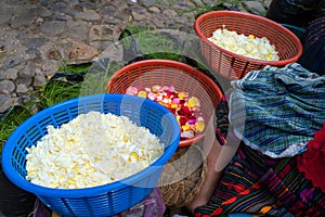 A Mayan woman is showing her flower petals at the Chichicastenango market in Guatemala.