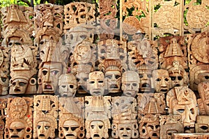 Mayan wood mask rows Mexico handcraft faces photo