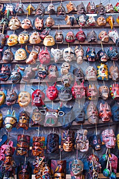 Mayan wooden masks for sale at Chichicastenango market photo