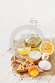 Mayonaise ingredients on white wood backgound