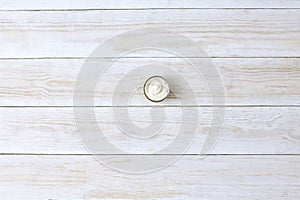 Mayonnaise in small bawl for dipping, on wooden background, top view