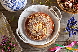 Mazanec, Czech sweet Easter pastry, with spring flowers, Easter eggs and pomlazka