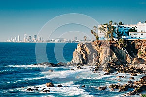 Mazatlan as seen from afar with a spectacular cliff line in the foreground