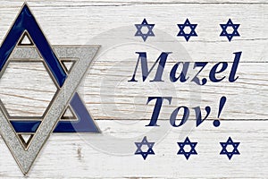 Mazel Tov message with star of David on weathered white wood