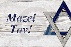 Mazel Tov message with star of David on weathered white wood