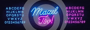 Mazel Tov neon lettering on brick wall background.