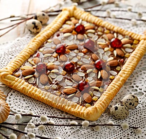 Mazurek pastry, traditional Polish Easter cake made of shortcrust pastry,  fudge caramel cream, candied fruit and almonds, closeup