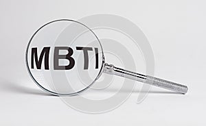 MBTI acronym through magnifying glass. Psychology typology test photo