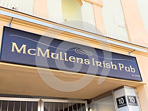 Mcmullens irish pub sign on building exterior