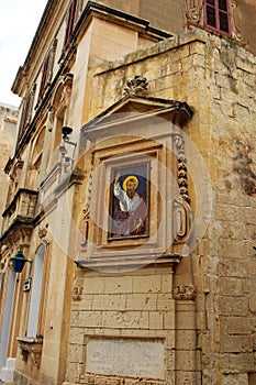 Mdina, Malta, July 2014. The ancient depiction of Saint Nicholas on a historic building in the city center.