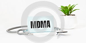 MDMA word on notebook,stethoscope and green plant