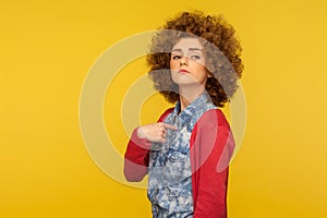 This is me! Portrait of proud confident egoistic woman with curly hair in casual outfit pointing herself