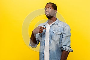 This is me, proud of myself. Portrait of successful arrogant young man pointing finger at himself. indoor studio shot