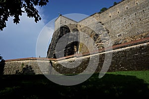 Meadow in front of massive wall with Elbsandstone rocks