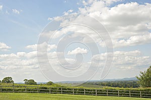 Meadow landskape, green valley and blue sky with white clouds in England