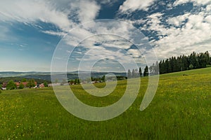 Meadows and forests near Javornik hill and village in Sumava national park