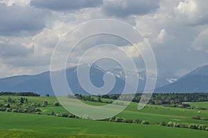 Meadows and High Tatras peaks panorama on background. Presov Reg