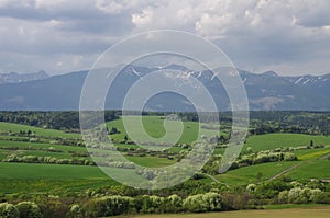 Meadows and High Tatras peaks panorama on background. Presov Reg