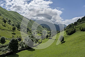 Meadows and rustic stone cabins in beautiful green valley
