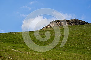 Meadows, sky and mountains