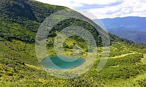 Meadows in the Svydovets mountain range. View of Lake Vorozheska