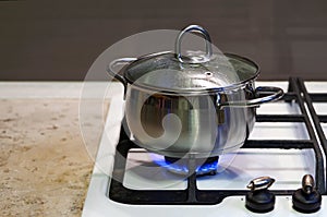 A meal is cooked in a stainless steel pan on a gas stove