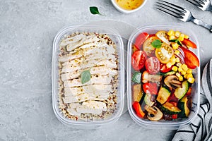 Meal prep containers with quinoa, grilled and fresh vegetables and chicken