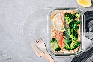 Meal prep lunch box containers with baked salmon fish, rice, green broccoli photo