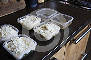 Meal prep. Stack of home cooked rice and chicken dinners in containers ready to be frozen for later use as quick and