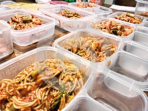 Meal preparations with spaghetti with shrimps and asparagus