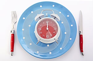 Mealtime table place setting with alarm clock