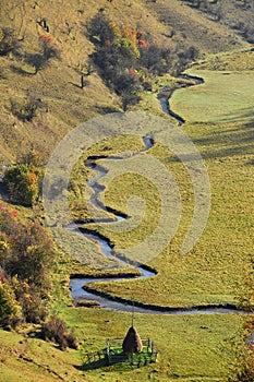 Meandering watercourse in a green meadow photo