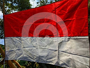 The meaning of the Indonesian flag, namely red means brave and white means holy.