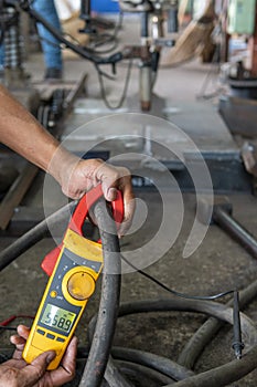 Measure amps while welding with digital clamp meter photo