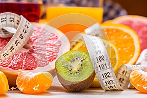 Measure tape and fresh citrus fruit orange lemon tangerine lime