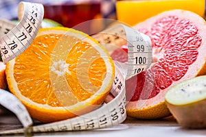 Measure tape and fresh citrus fruit orange lemon tangerine lime