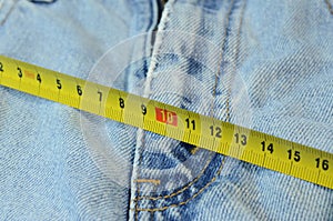 Measure tape on jeans background