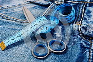 Measure tape wound around metal scissors as making clothes concept