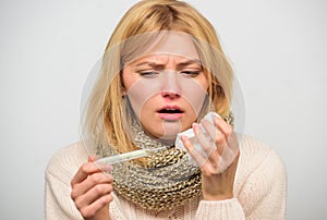 Measure temperature. Woman feels badly ill sneezing. Girl in scarf hold thermometer and tissue close up. Cold and flu