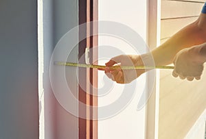 Measure the thickness of the decorative edge of the wall. Yellow tape measure Inspect the construction of the door frame