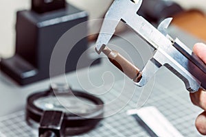 Measurement of a cartridge from a firearm with a caliper rule. Forensic laboratory. Ballistic examination.