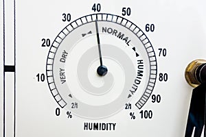 Measurement and control of humidity. Meteo weather indicator hygrometer face with black scale, needle and numbers. Closeup of
