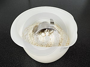 Measurement tool in a bowl of wheat flour