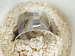 Measurement tool in a bowl of wheat flour