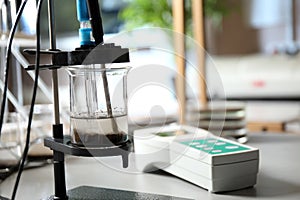 Measuring acidity and pH of soil on table