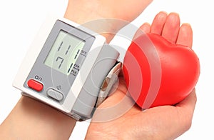 Measuring blood pressure and red heart in hand