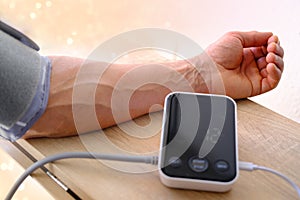 measuring blood pressure, Senior man working with blood pressure machine at home to check his health, concept of health and heart